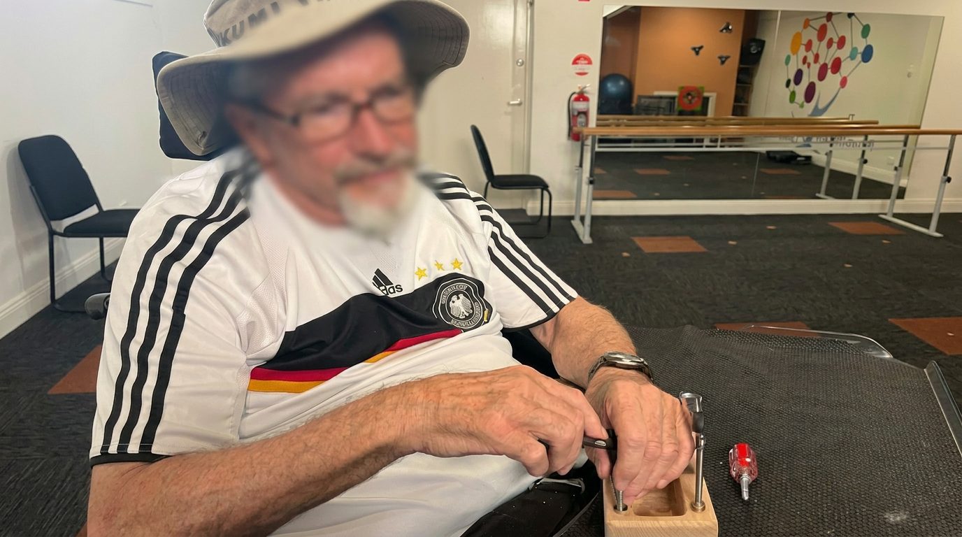 Participant practising fine motor and hand coordination tasks during neurological rehabilitation